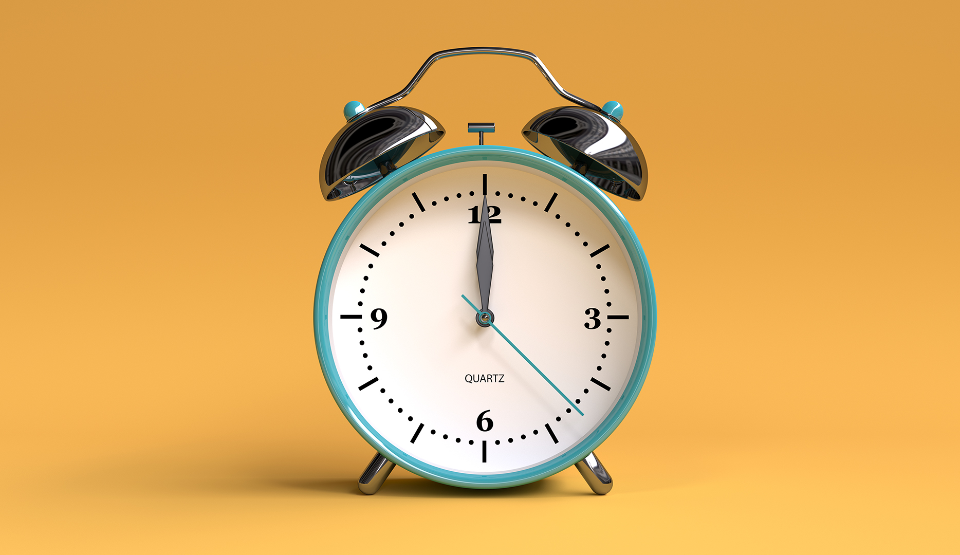 classic alarm clock on yellowish background